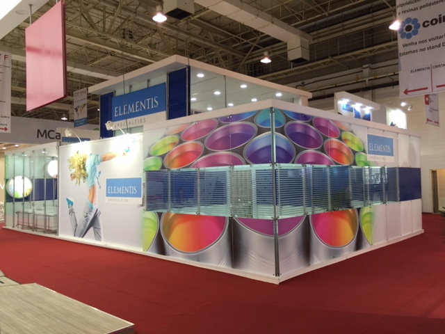 Elementis island booth wrapped in colorful paint-can graphics at a trade fair