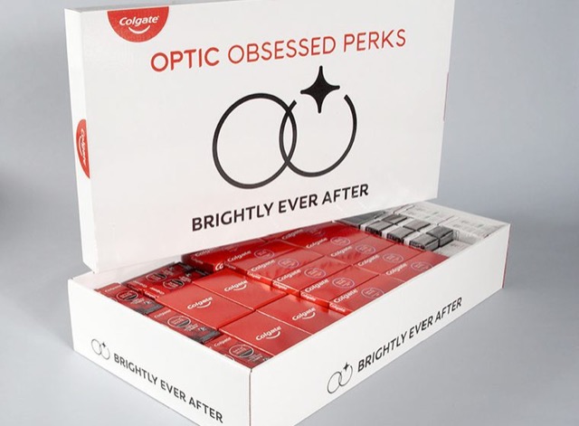 Custom Colgate promotional kit box packed with rows of red and white toothpaste cartons
